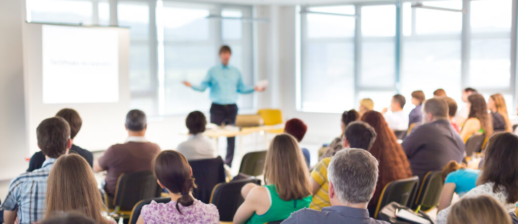 Speakers Giving a Talk at Business Meeting. Audience in the conference hall. Business and Entrepreneurship concept.